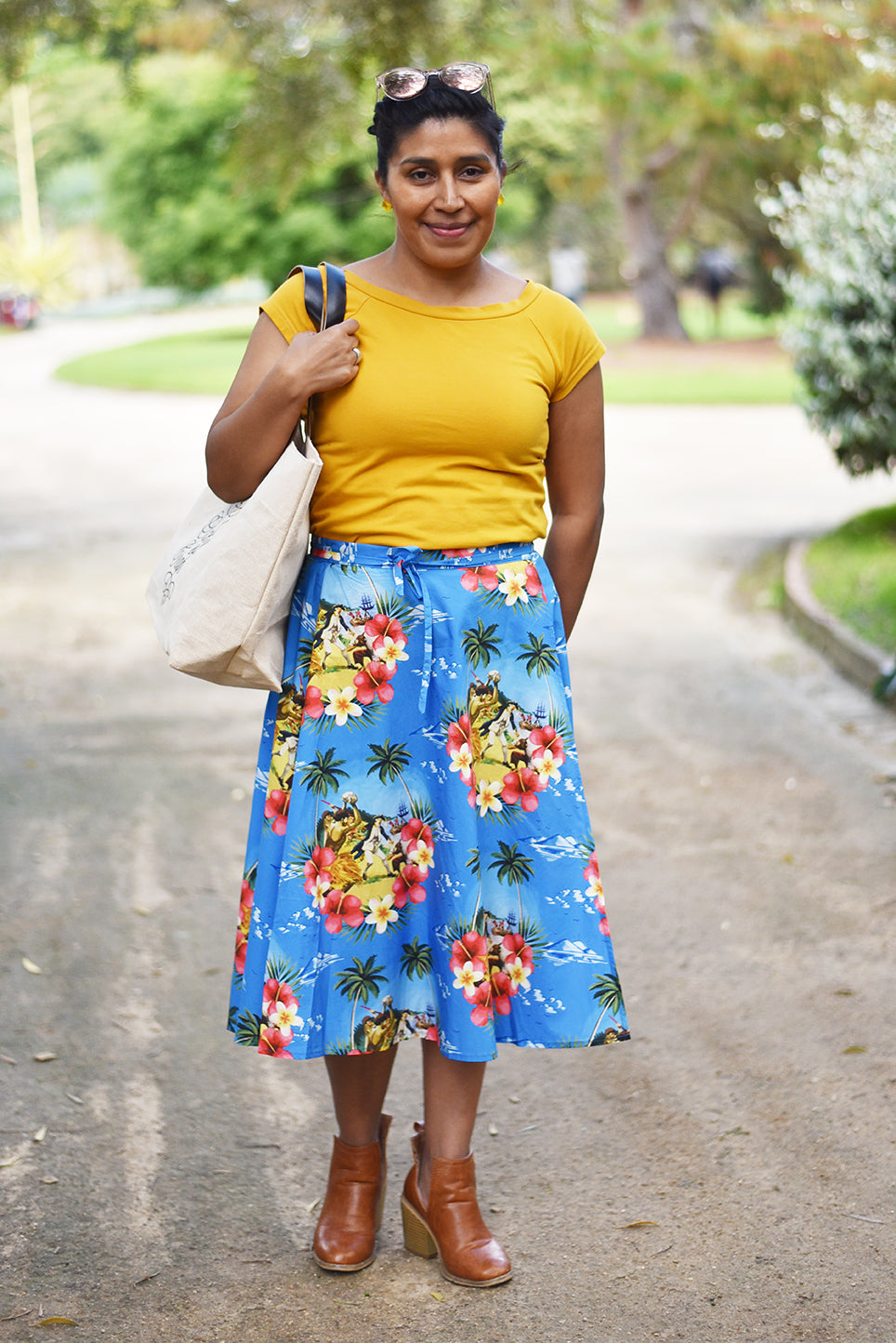 Cooked Hawaiian Wraparound Skirt - Cooked Concepts (Cooked Hawaiian Shirt - Cooked Concepts Commemorate when serial coloniser Captain Cook tried to get fresh with the Native Hawaiians on Valentines Day 1779 and met his grisly end. Cooked Concepts-designed fabric and beautifully made by hand, these skirts, inspired by an Alfred Shaheen design are the softest pure cotton. Josie has paired the Cooked Skirt with a mustard yellow tee (not by us) and our Sack of Crap (definitely by us).