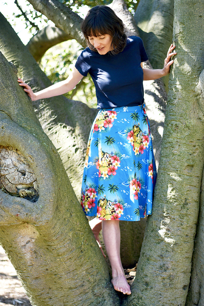 Cooked Hawaiian Wraparound Skirt - Cooked Concepts (Cooked Hawaiian Shirt - Cooked Concepts Commemorate when serial coloniser Captain Cook tried to get fresh with the Native Hawaiians on Valentines Day 1779 and met his grisly end. Cooked Concepts-designed fabric and beautifully made by hand, these skirts, inspired by an Alfred Shaheen design are the softest pure cotton. Ally has paired the Cooked Skirt with a navy blue tee (not by us).